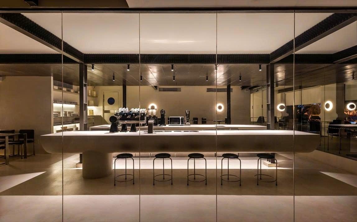Dimly lit display case with pastries and bottled drinks in a cafe